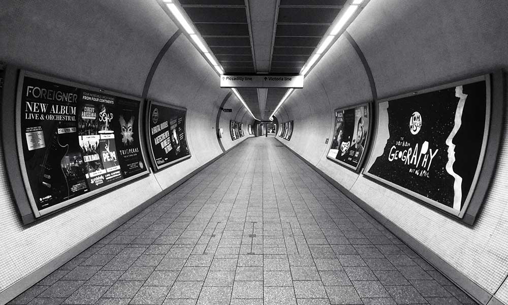 advertisements on side walls in corridor between Piccadilly and Victoria in the london underground